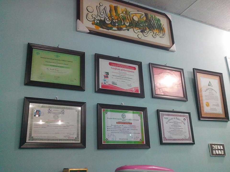Framed professional certificates displayed in the clinic