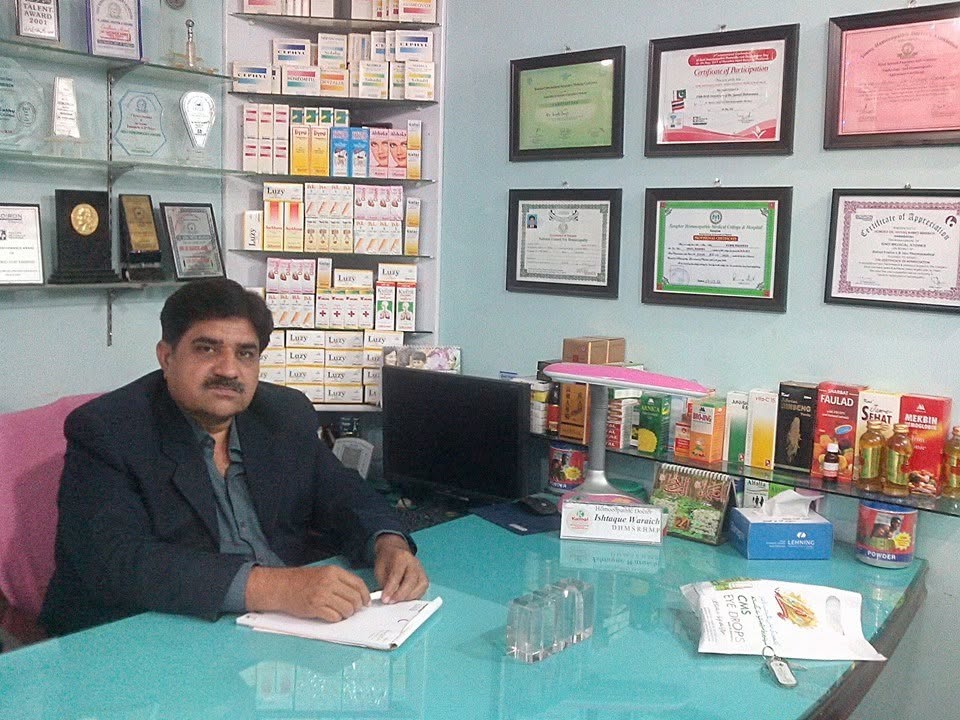Dr. Ishtiaque Ahmed seated at his clinic desk